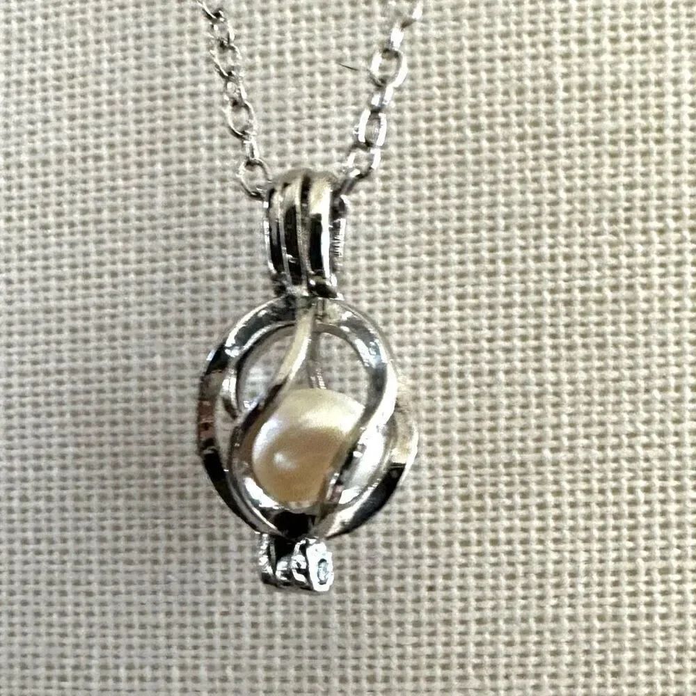 Silver tone pearl caged pendant necklace
